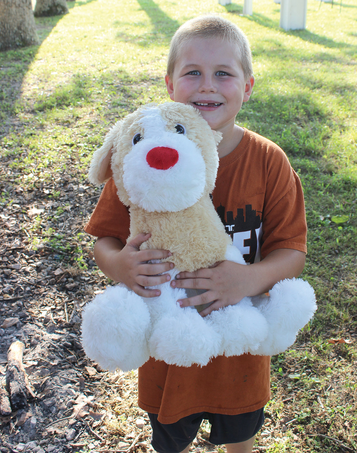 Eli Iott with the stuffed animal he won from playing a darts game.